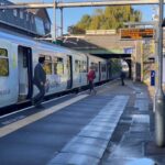 Two passengers getting out of train 